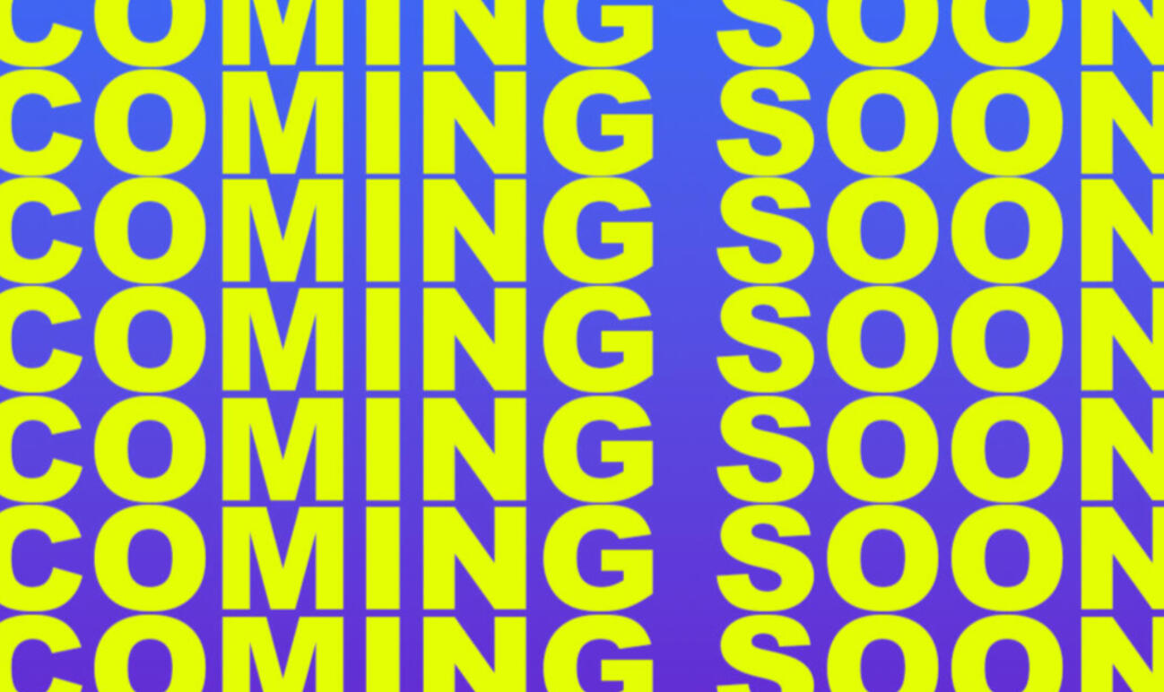 Still from performance by Keeva Lough. Features Keeva turned around with arms up facing white stage where text is being projected onto.