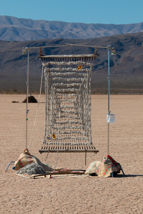 Image of photos by Anna Newman. Features three photo prints displayed on wooden temporary wall, of AI generated images of Reno houses.