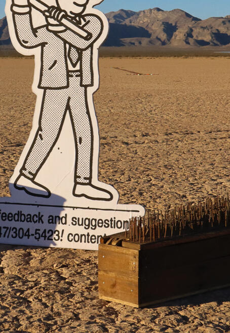 Image of sculpture by Alisha Kerlin. Features numerous Christmas decorations of various sizes tied together and to an anchor point on the lake-bed.